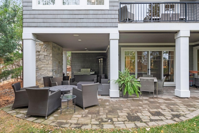 view of patio / terrace with an outdoor living space and a balcony