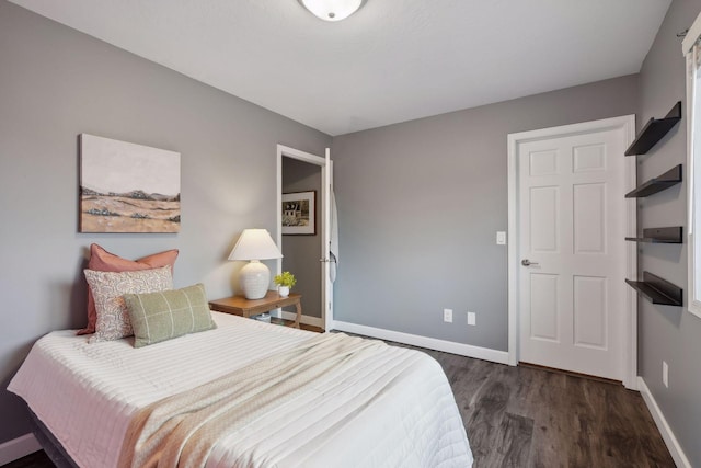 bedroom with dark hardwood / wood-style flooring