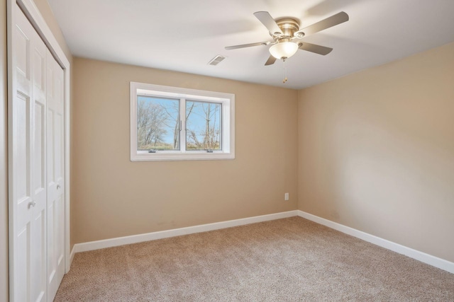 unfurnished bedroom featuring ceiling fan and light carpet