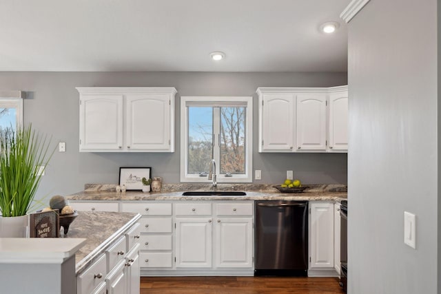 kitchen with electric range, dishwasher, white cabinets, and sink