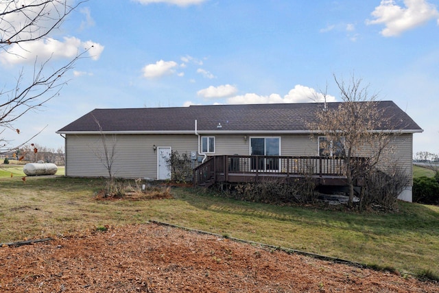 rear view of property with a yard and a wooden deck