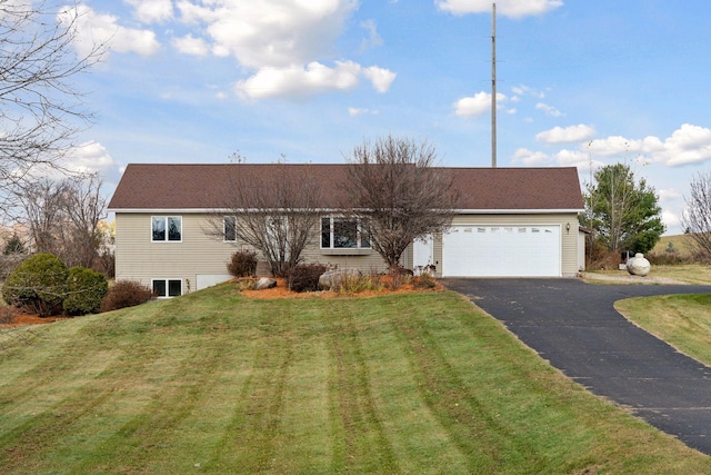 ranch-style house featuring a garage and a front lawn