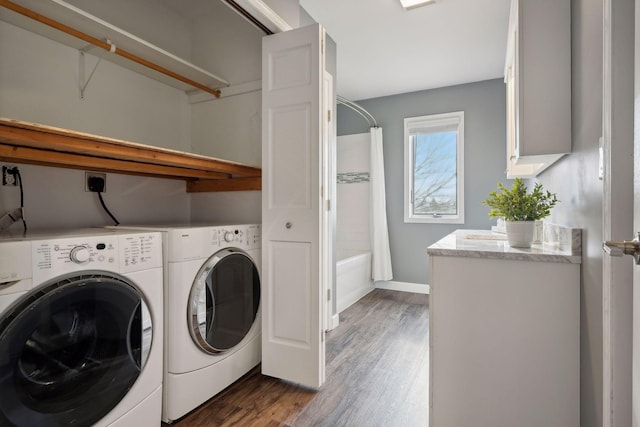 washroom with washer and clothes dryer and dark wood-type flooring