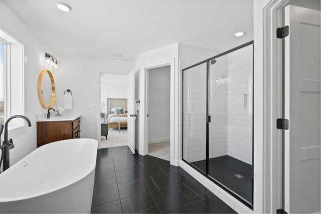 bathroom with vanity, a textured ceiling, and shower with separate bathtub