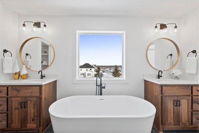 bathroom featuring vanity and a tub