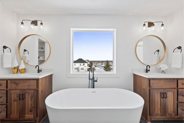 4098 Gable Ln, Woodbury, MN 55129 - full bathroom featuring two vanities, a soaking tub, and a sink