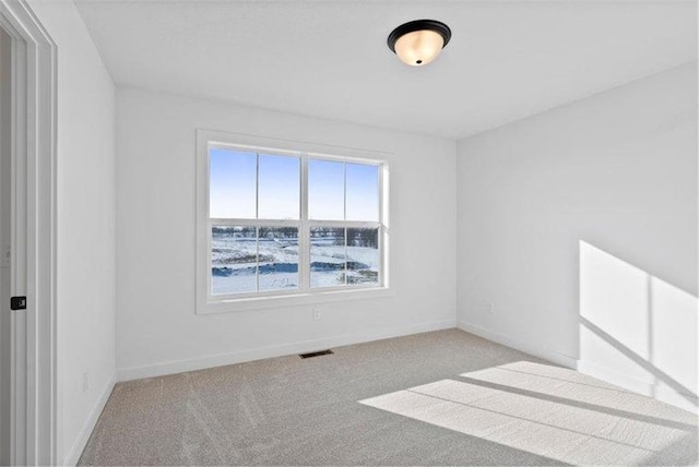 4098 Gable Ln, Woodbury, MN 55129 - spare room with baseboards, visible vents, and light colored carpet