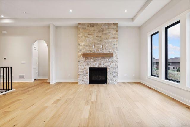 unfurnished living room with a fireplace and light hardwood / wood-style flooring