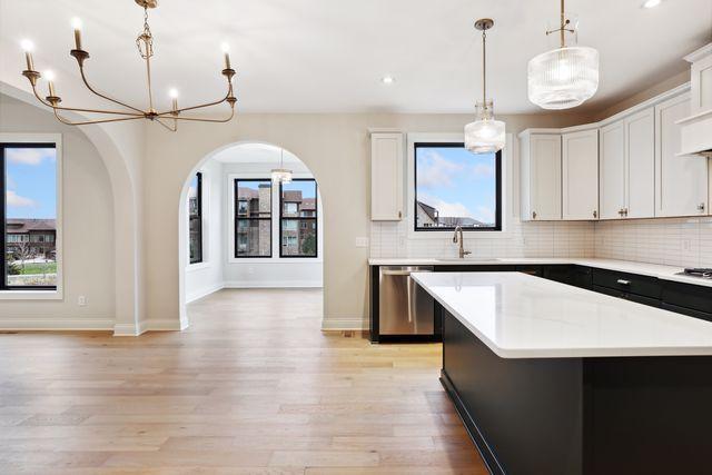 kitchen with white cabinetry, plenty of natural light, and a center island