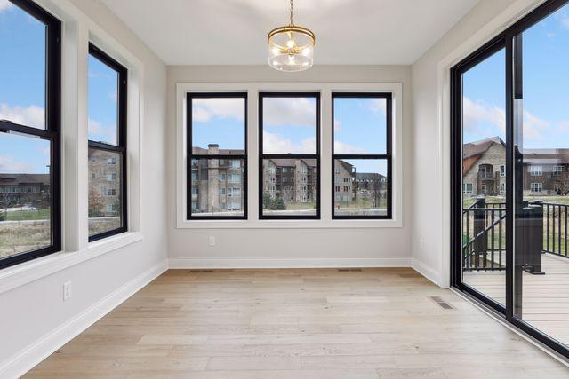 unfurnished sunroom featuring an inviting chandelier and a wealth of natural light