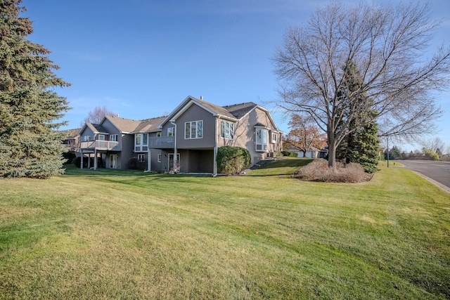 view of property exterior with a lawn