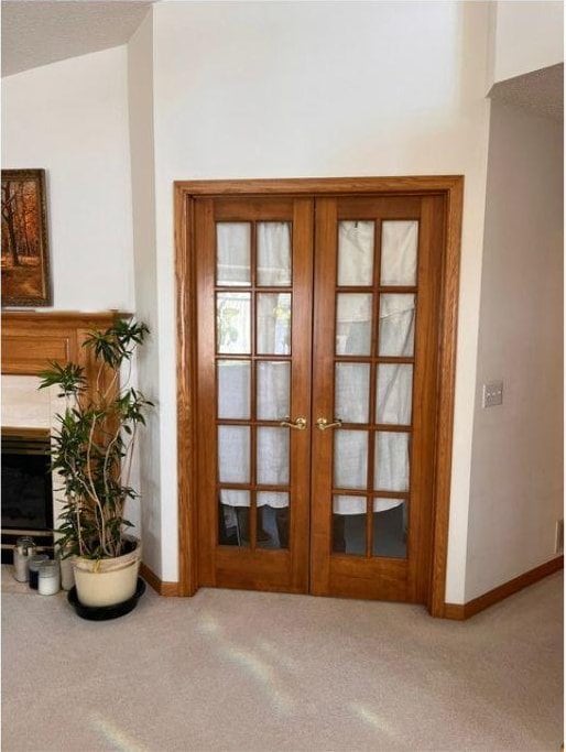 doorway to outside with carpet flooring, vaulted ceiling, and french doors