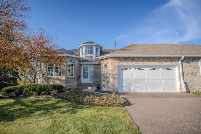 view of front of property with a garage and a front lawn