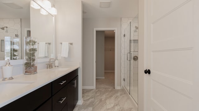 bathroom with vanity and a shower with shower door