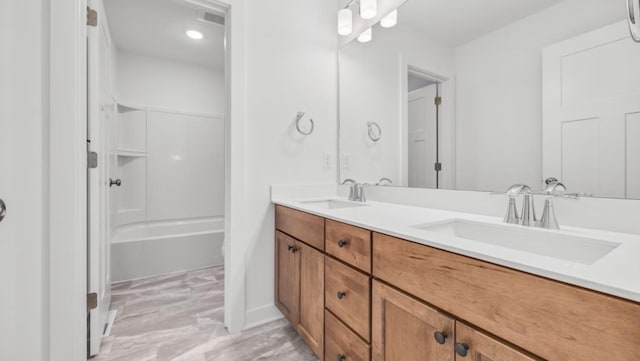 bathroom with a sink and double vanity