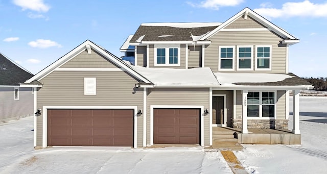 view of front of house featuring a garage, stone siding, and a shingled roof