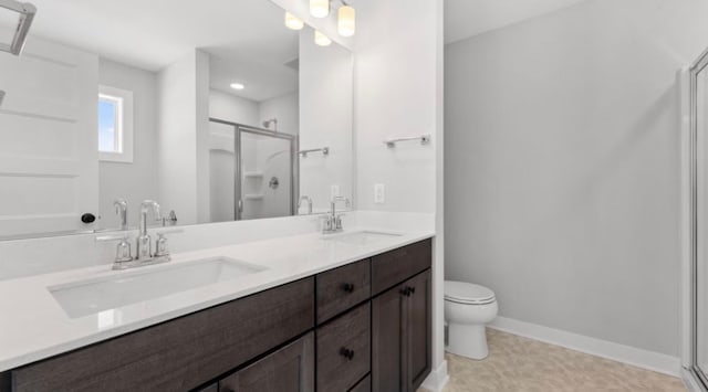 full bath featuring double vanity, a stall shower, and a sink