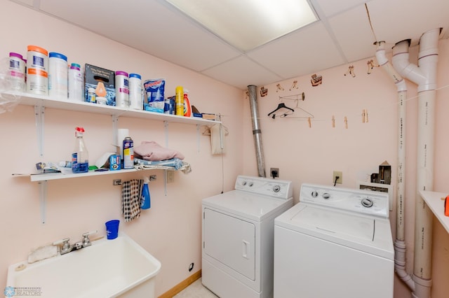 clothes washing area with sink and separate washer and dryer