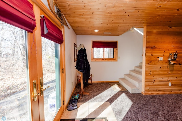 doorway to outside with plenty of natural light, tile patterned floors, and wood ceiling