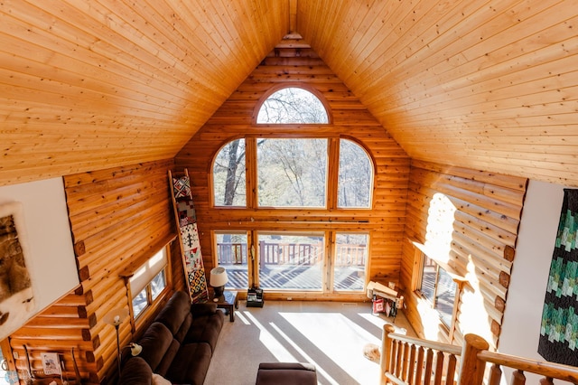 unfurnished living room with high vaulted ceiling and wooden ceiling