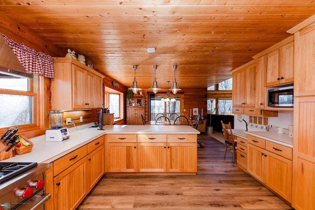 kitchen featuring appliances with stainless steel finishes, pendant lighting, wood ceiling, kitchen peninsula, and light hardwood / wood-style flooring