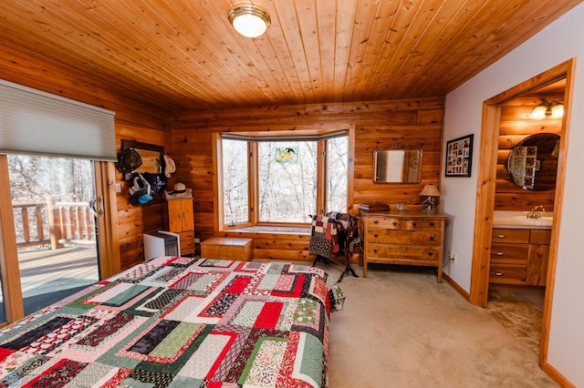 carpeted bedroom featuring wood walls, wood ceiling, and sink