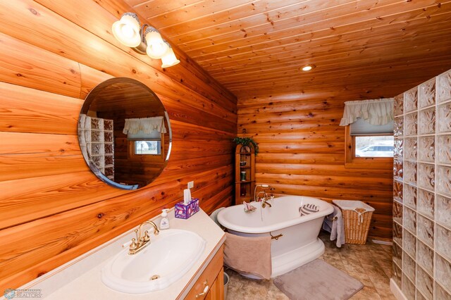 bathroom with a bath, wooden ceiling, vanity, and tile patterned floors