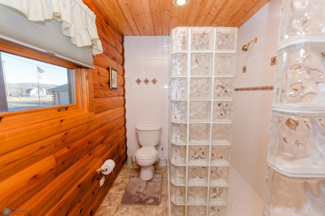 bathroom featuring toilet, tile patterned flooring, wood walls, wooden ceiling, and walk in shower