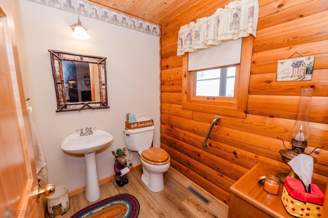 bathroom featuring toilet, wood-type flooring, and wooden ceiling