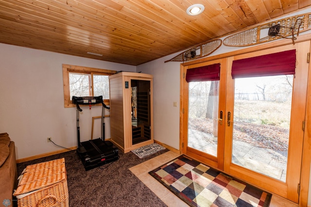 workout room featuring french doors, carpet, and wood ceiling