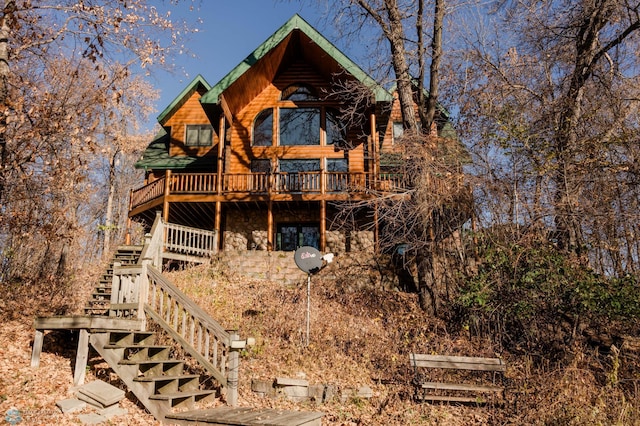 rear view of property with a wooden deck