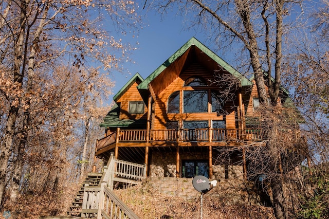 back of house featuring a deck