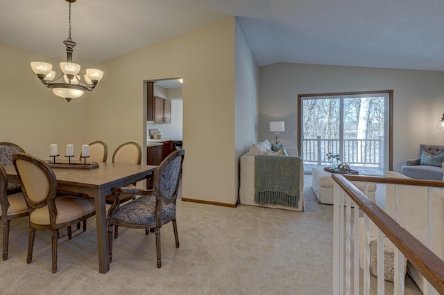 dining space featuring an inviting chandelier, light colored carpet, and lofted ceiling