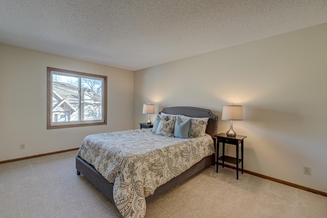 bedroom with light colored carpet and a textured ceiling