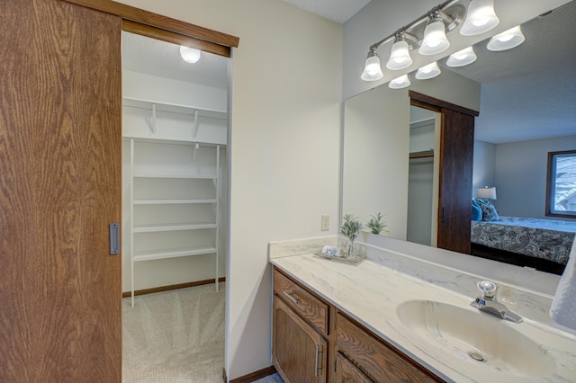 bathroom with vanity and a textured ceiling