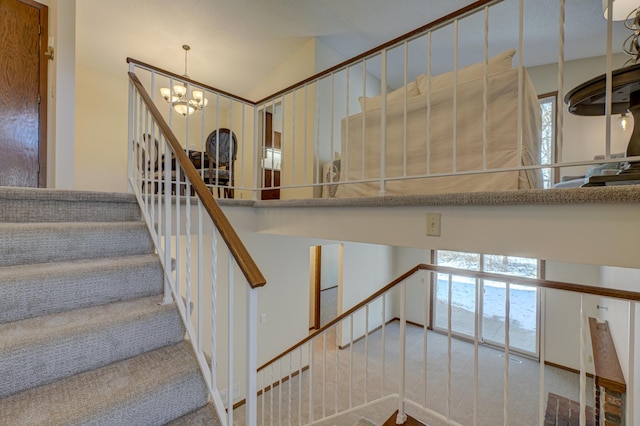 stairway featuring lofted ceiling, a chandelier, and carpet flooring