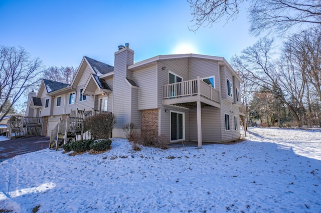 view of snow covered exterior featuring a balcony