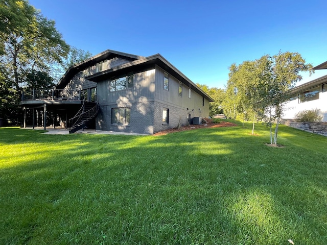 view of home's exterior featuring a deck, a yard, and central AC