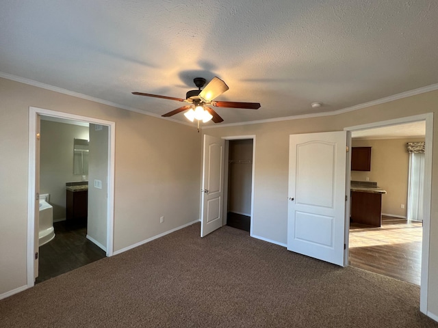 unfurnished bedroom with a textured ceiling, ornamental molding, ceiling fan, and connected bathroom