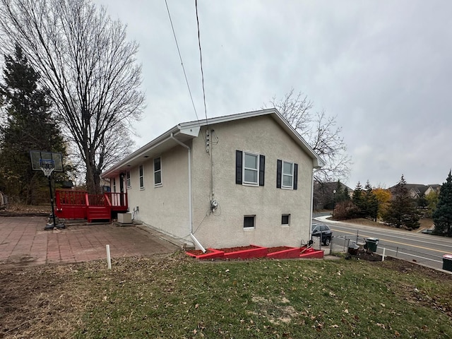 back of property with central air condition unit, a yard, and a patio