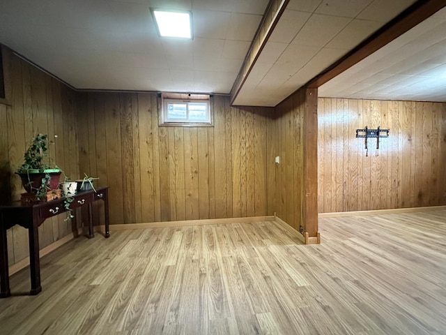 basement featuring hardwood / wood-style floors and wooden walls