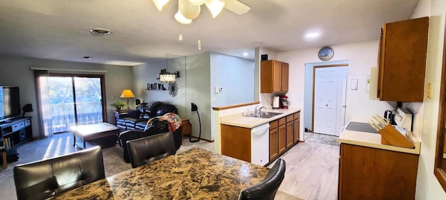 kitchen with sink, decorative light fixtures, light hardwood / wood-style flooring, white dishwasher, and stove