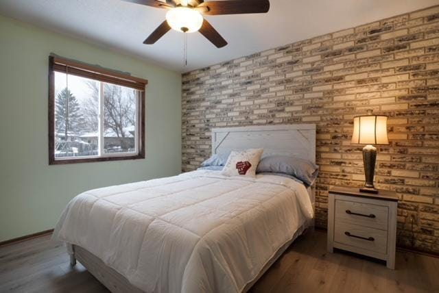 bedroom featuring hardwood / wood-style floors and ceiling fan