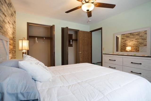 bedroom featuring multiple closets and ceiling fan