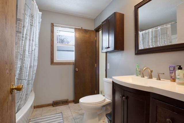 full bathroom with tile patterned flooring, vanity, shower / bath combo with shower curtain, and toilet