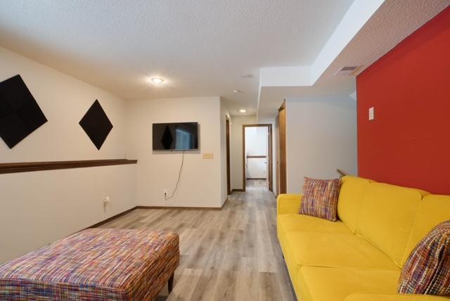 living room with light hardwood / wood-style floors and a textured ceiling