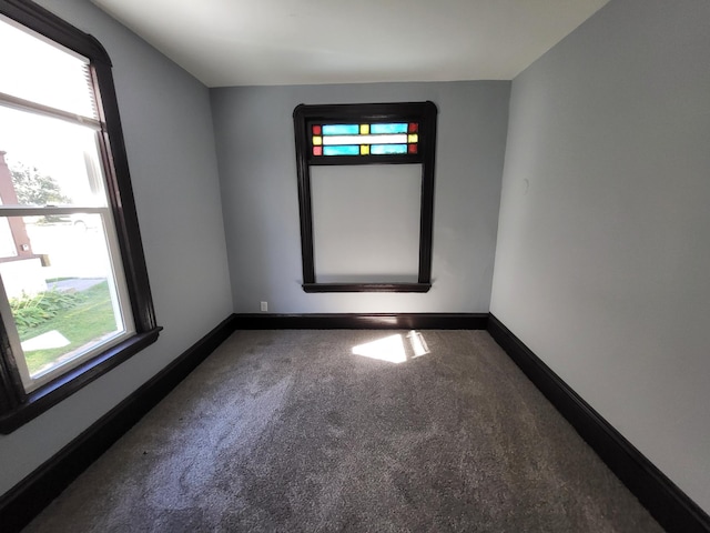 carpeted spare room featuring a healthy amount of sunlight