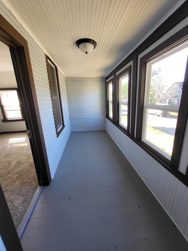 unfurnished sunroom featuring wooden ceiling