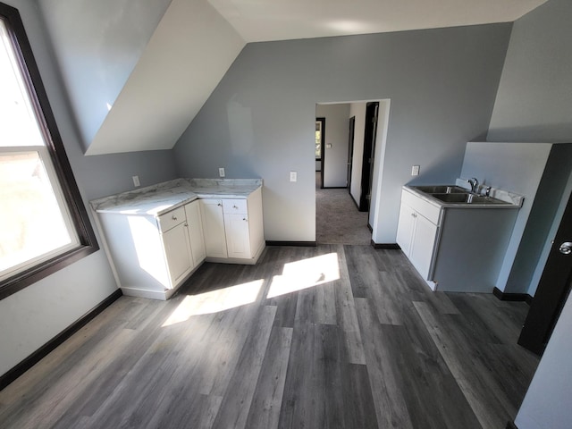 kitchen with lofted ceiling, sink, dark hardwood / wood-style floors, and white cabinets