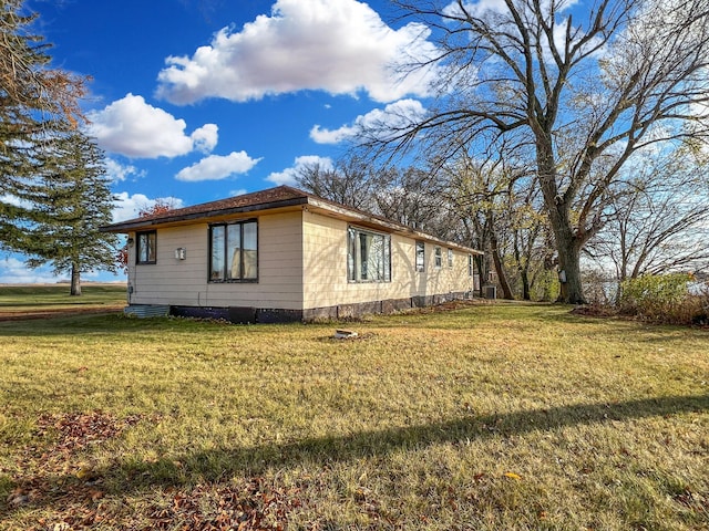 view of side of property with a lawn